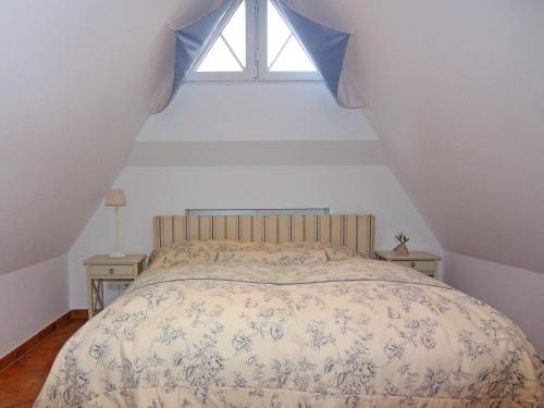 a bedroom with a bed with a window at Semi-detached house, Zingst in Zingst