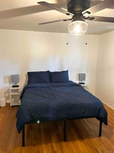 a bed in a bedroom with a ceiling fan at 5BR House Close to Stadium/Downtown in Ann Arbor
