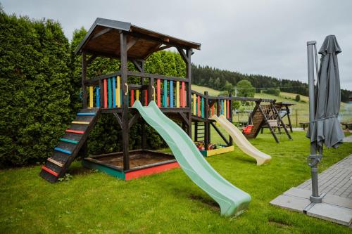 a play structure with a slide and a slideintend at Apartmány Velké Karlovice in Velké Karlovice