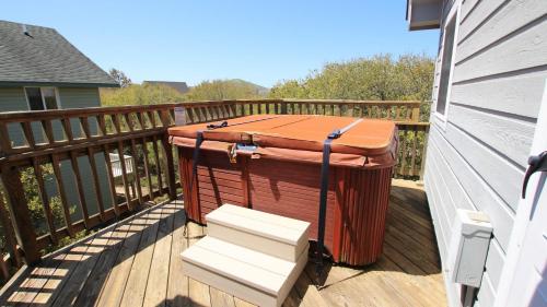 a wooden deck with a hot tub on a house at Oceanside, Private Pool, Hot Tub, Scrn Prch, OS2N, It doesn't get better than this in Corolla