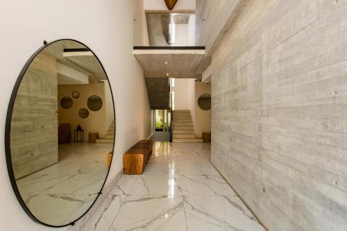 a large mirror on a wall in a hallway at Riva Condos by The Spot Rentals in Playa del Carmen