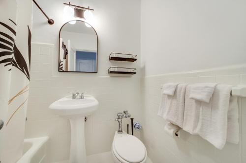 a white bathroom with a sink and a mirror at Tropics Hotel Miami Beach in Miami Beach