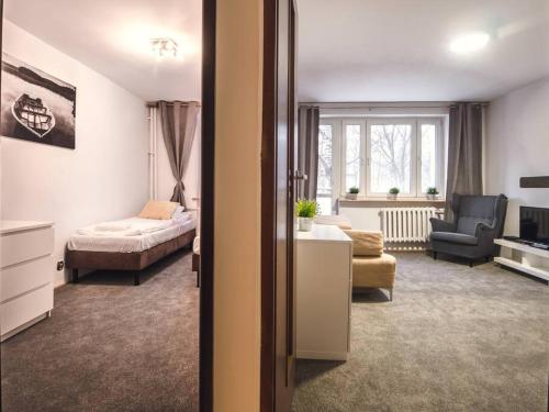 a room with a bed and a living room with a couch at 71, ***3beds: Deluxe Warm Suite in Warsaw Manhattan*** in Warsaw