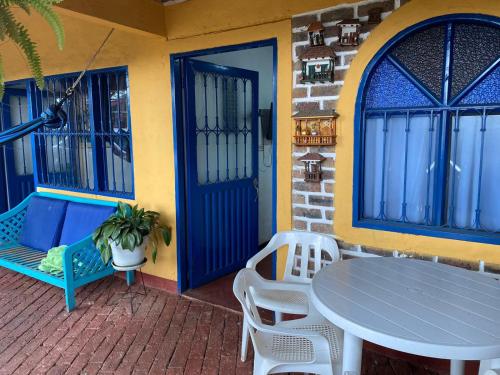 patio con tavolo, sedie e porta blu di DinoAgro Potrero Grande a Moniquirá