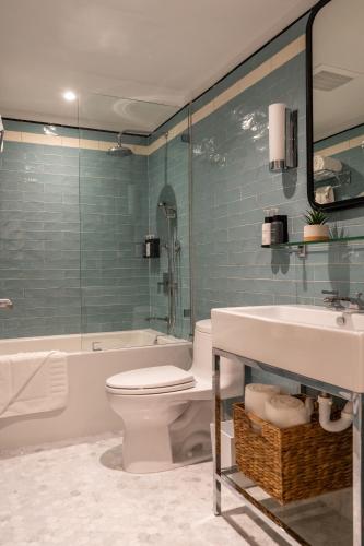 a bathroom with a toilet and a sink and a shower at Nassau Suite South Beach, an All Suite Hotel in Miami Beach