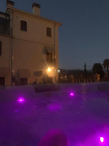 a pool with purple lights in front of a building at VILLA MARGHERITA in Pieve di Soligo