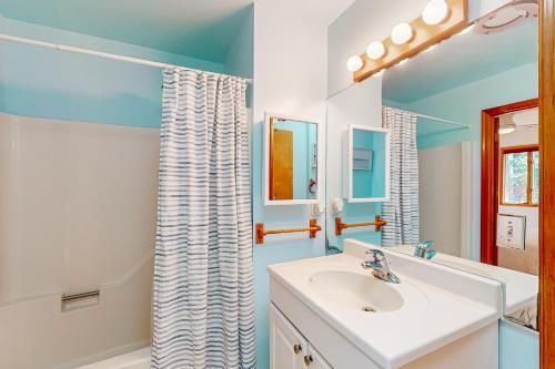 a bathroom with a sink and a shower at The Red House at the Beach in Ocean Pines