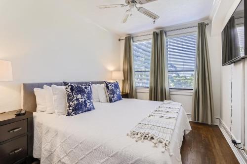 a bedroom with a bed with blue and white pillows at Palm Beach Hotel in Palm Beach