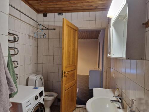 a small bathroom with a sink and a toilet at Prästö in Närpiö