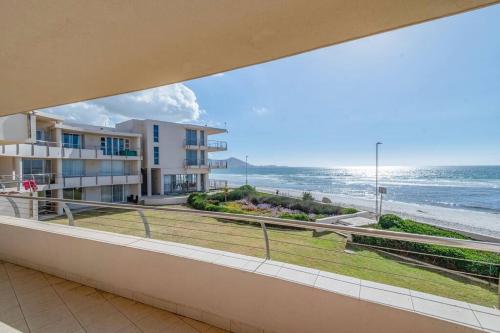 a balcony with a view of the ocean at Oceanfront Residence in Lagoon Beach in Cape Town