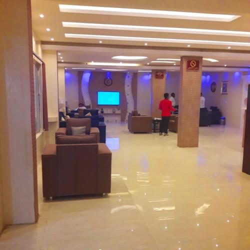 a lobby with couches and a tv in a building at اجواء المساء للشقق المخدومة in Wadi Al Dawasir
