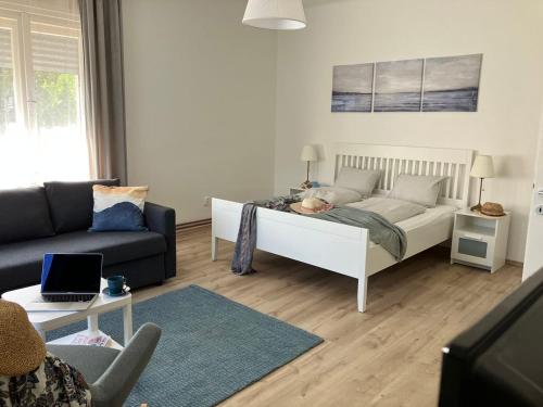 a living room with a bed and a couch at Tündér Villa in Balatonfüred
