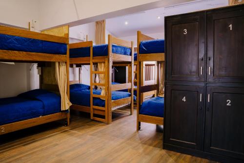 a group of bunk beds in a room at Magar Hostel Bar in Cusco