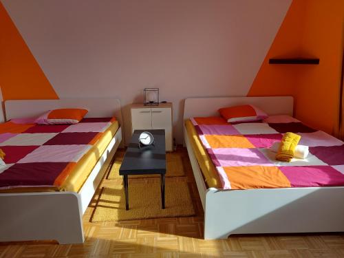 a bedroom with two beds and a table with a lamp at Zagreb apartment Toni in Zagreb