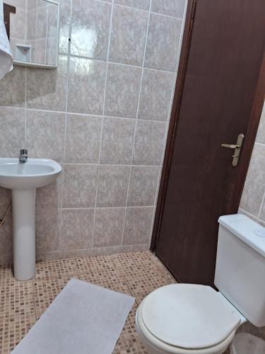 a bathroom with a toilet and a sink at Pousada Sol e Lua in Caraguatatuba
