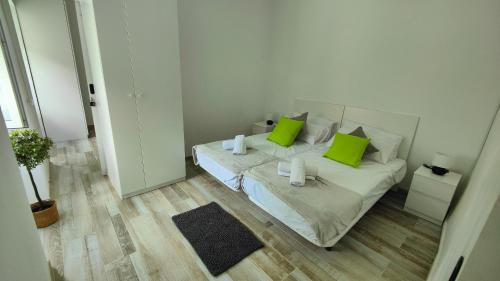 a small bedroom with a bed with green pillows at Casa Carlota in Hermigua