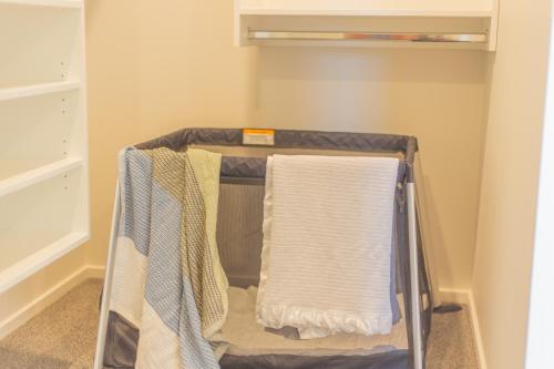 a towel rack with towels on it in a closet at New Luxury Home with Games Room and Park Outlook Sleeps 12, 26 mins from CHC airport in Lincoln