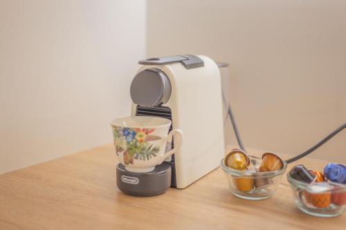 a coffee maker sitting on a table with two cups at New Luxury Home with Games Room and Park Outlook Sleeps 12, 26 mins from CHC airport in Lincoln