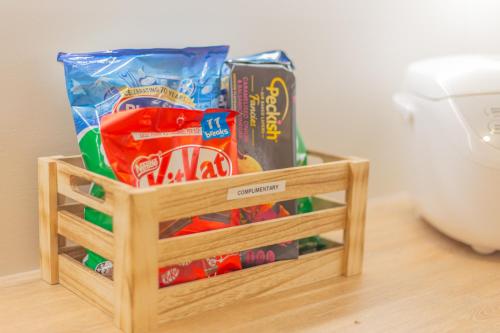 a wooden crate filled with chips and other snacks at New Luxury Home with Games Room and Park Outlook Sleeps 12, 26 mins from CHC airport in Lincoln