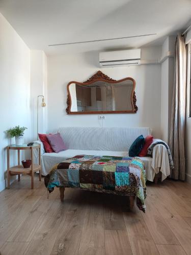 a bedroom with a bed and a mirror on the wall at Apartamento Elvira in Granada
