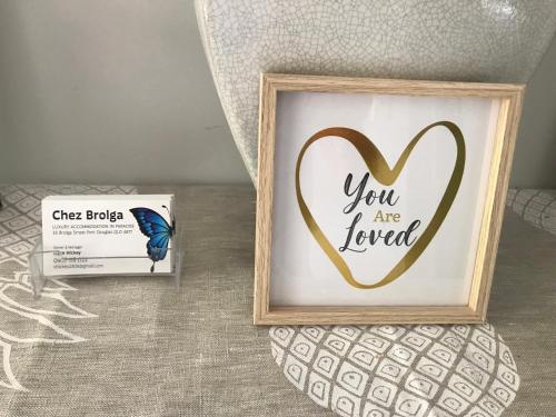 a picture of a heart with a butterfly next to a box at Chez Brolga in Port Douglas