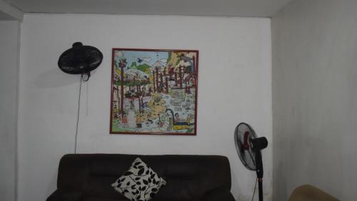 a living room with a couch and a picture on the wall at Gran Hotel Caravana in Cúcuta