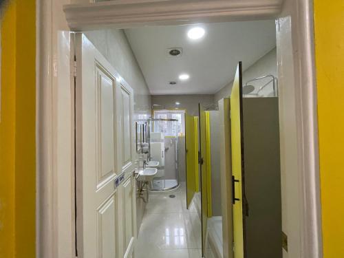 a bathroom with yellow and green walls and a sink at Owls Hostel in Porto