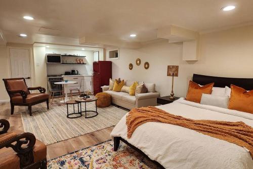 a bedroom with a large bed and a living room at Starlight Guesthouse in West Orange