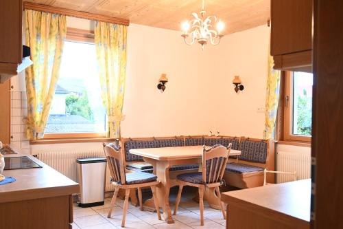 a kitchen with a dining room table and chairs at Gîte l'Avant in Rouffach