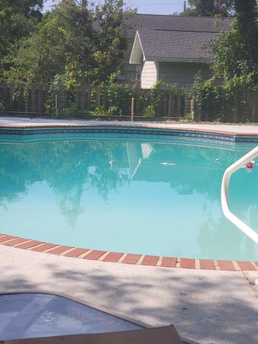 une grande piscine avec de l'eau bleue dans une cour dans l'établissement Historic GWALTNEY HOUSE-Cottage at St Andrew's Bay, à Panama City