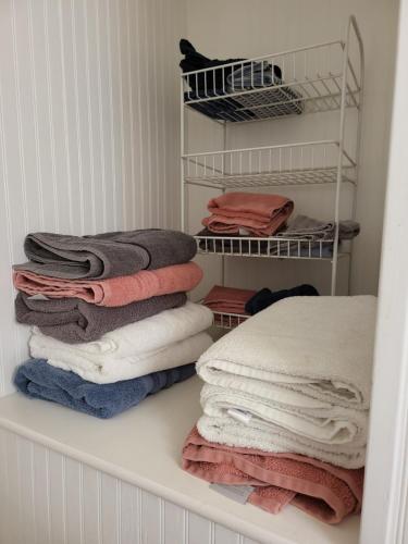 a pile of towels on a shelf in a closet at Historic GWALTNEY HOUSE-Cottage at St Andrew's Bay in Panama City