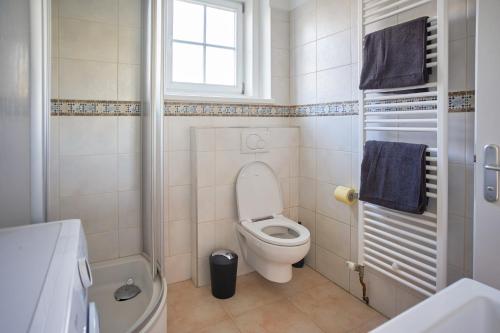 a small bathroom with a toilet and a window at revLIVING Apartment Quintus Baden City Center in Baden