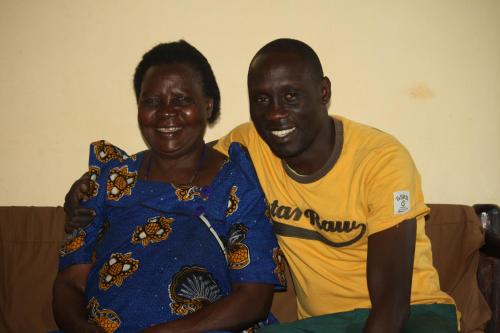 a man and a woman sitting on a couch at wild-west guest house in Bunono