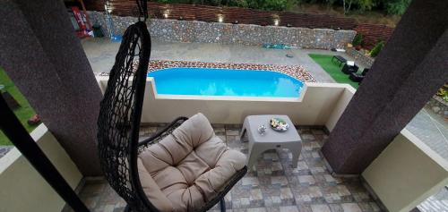 an overhead view of a chair and a swimming pool at Vila Bate Bole 