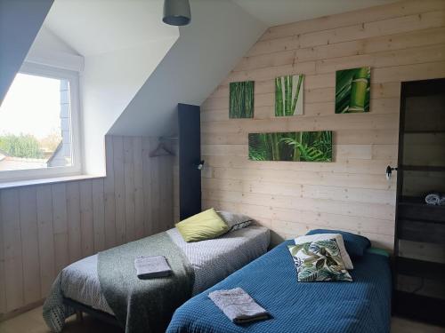 a small room with two beds and a window at Relais de Moidrey in Moidrey