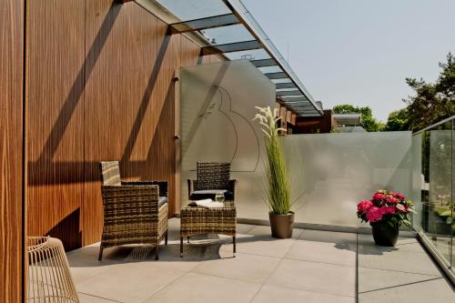 a patio with two chairs and a table at Apartamenty Belni Hel Edyta i Maciej Wolak in Hel
