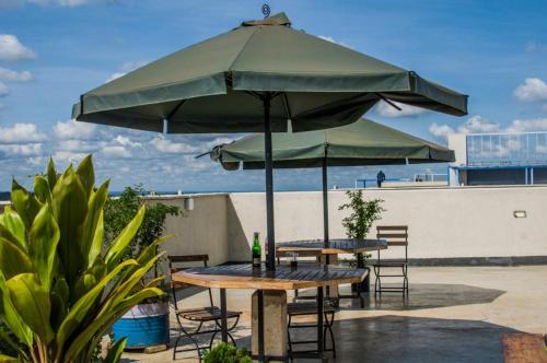 a table and chairs under a large umbrella at Happy Homes BnB in Nairobi