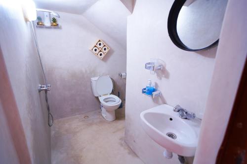 a small bathroom with a toilet and a sink at Caban Surf Tamraght in Tamraght Ouzdar