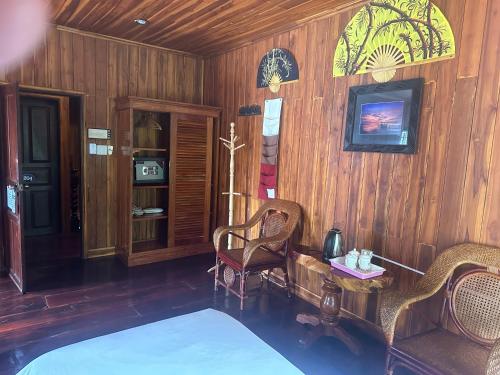 a bedroom with a bed and a table and chairs at Khounphet Heritage House in Luang Prabang