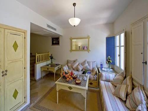a living room with a couch and a table at Diar Lemdina Hotel in Hammamet