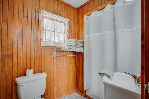 a bathroom with a white toilet and a sink at Lakeshore Cabin 5 on the Lake in Lake Ozark