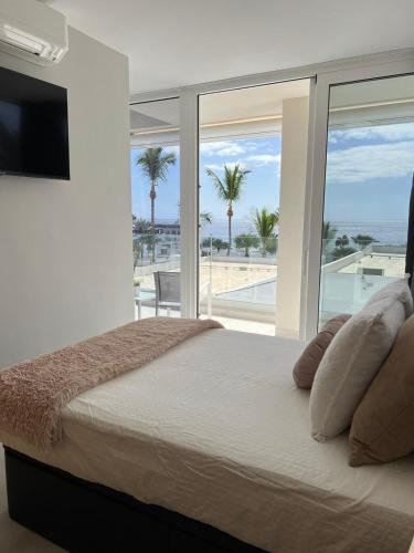 a bedroom with a bed with a view of the ocean at Beach Paradise in Tías