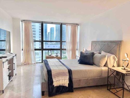 a bedroom with a large bed and a large window at 2BD Close to views Sky-Rise 14 in Miami
