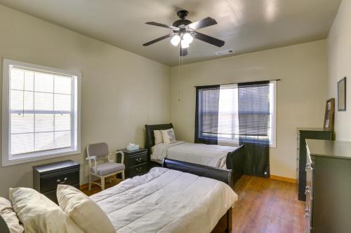 a bedroom with two beds and a ceiling fan at Spacious Albany Retreat Near Flint River Trail! in Albany