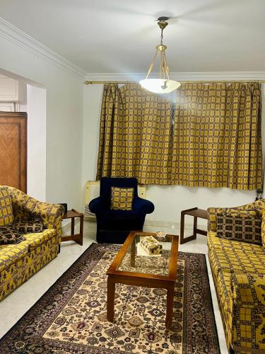 a living room with two couches and a coffee table at Central private room in downtown kasr nile in Cairo