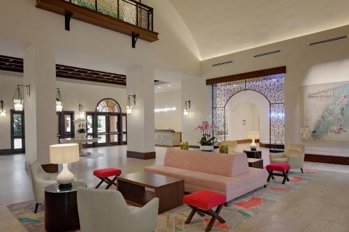 a living room with a couch and a table and chairs at The Alfond Inn in Orlando
