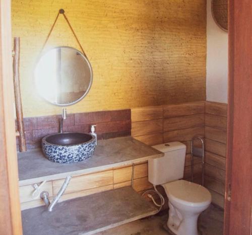 a bathroom with a sink and a toilet at Magaral Casa de Praia in Pôrto de Pedras