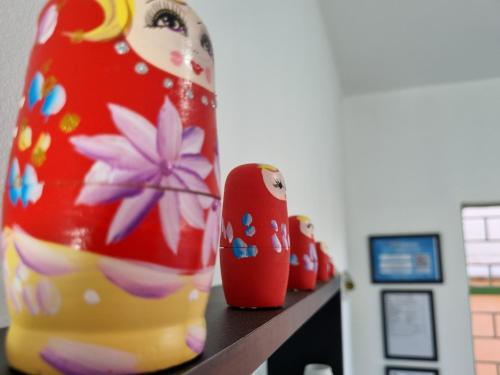 a row of vases sitting on a shelf at Hostel Kaizen in Curitiba