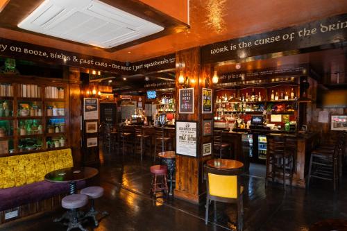 a bar with many bar stools in a room at The Hyde - At Dunning's Bar in Watford