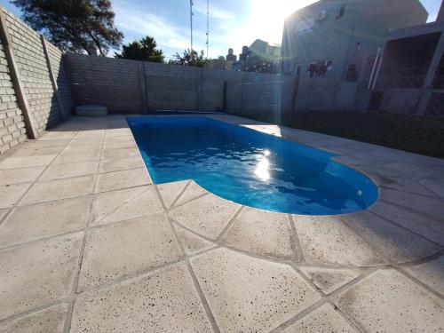 una piscina con agua azul en un patio trasero en La Casita en Tandil en Tandil